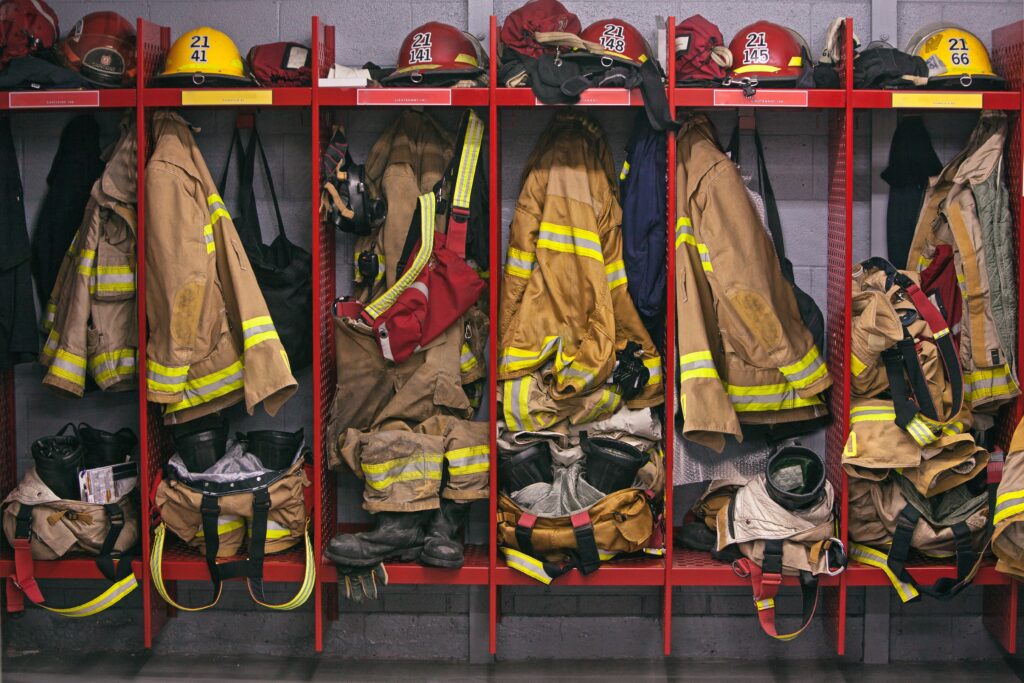 Firefighter gear hung and placed in open shelf lockers.